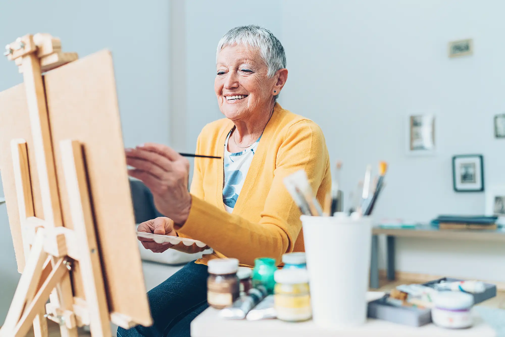 senior woman smiling and painting